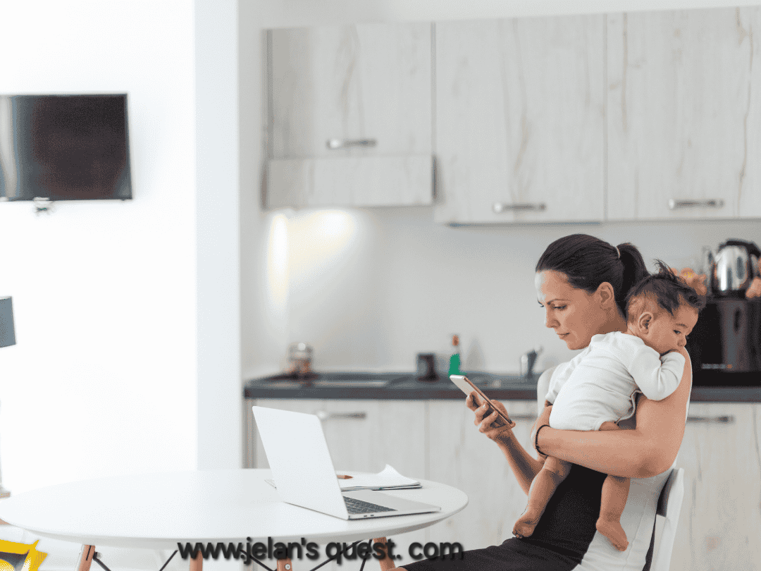 A-mother-working-from-home-on-her-laptop-while-holding-her-baby-in-her-arms