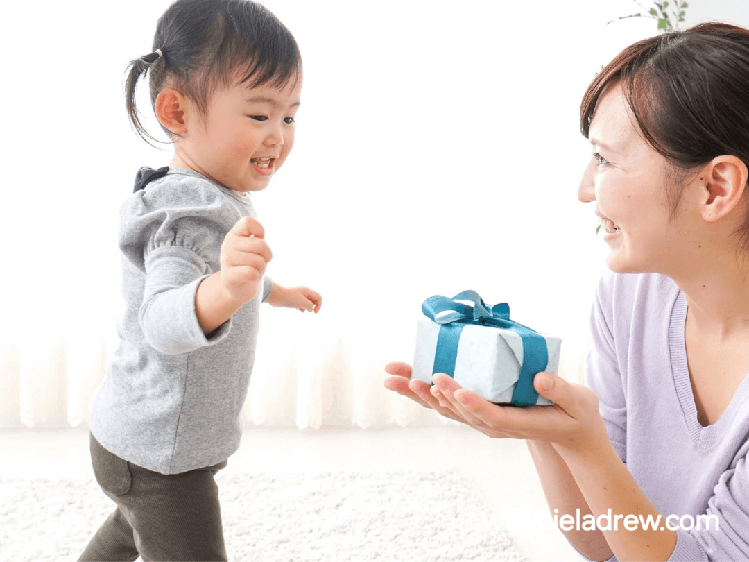 Parent-smiling-and-giving-a-reward-to-a-toddler-showing-encouragement-practical-parenting-advice