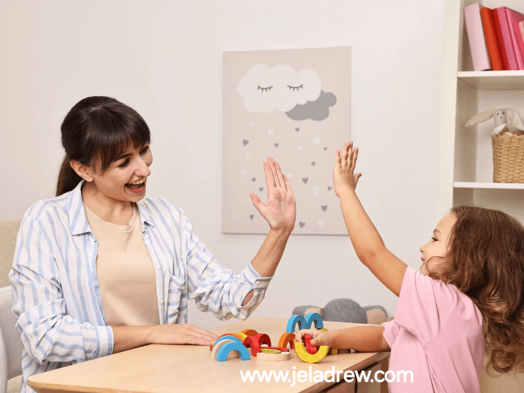 Parent-giving-a-high-five-to-a-toddler-playing with-toys-on-the-table-showing-positive-and-consistent-parenting-toddler-tips