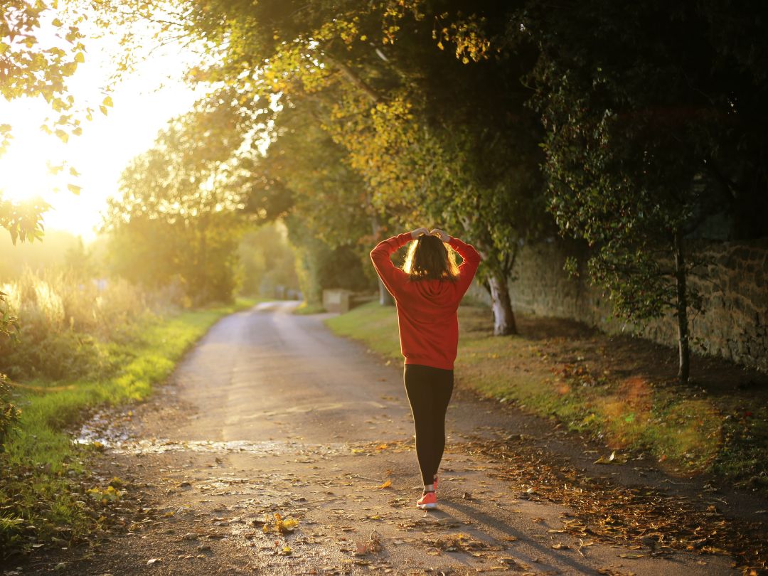 A-woman-walking-confidently-in-a-sun-lit