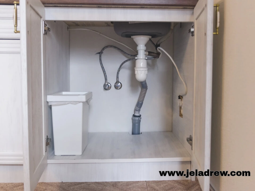 neatly-organized-kitchen-under-sink-and-trash-bin