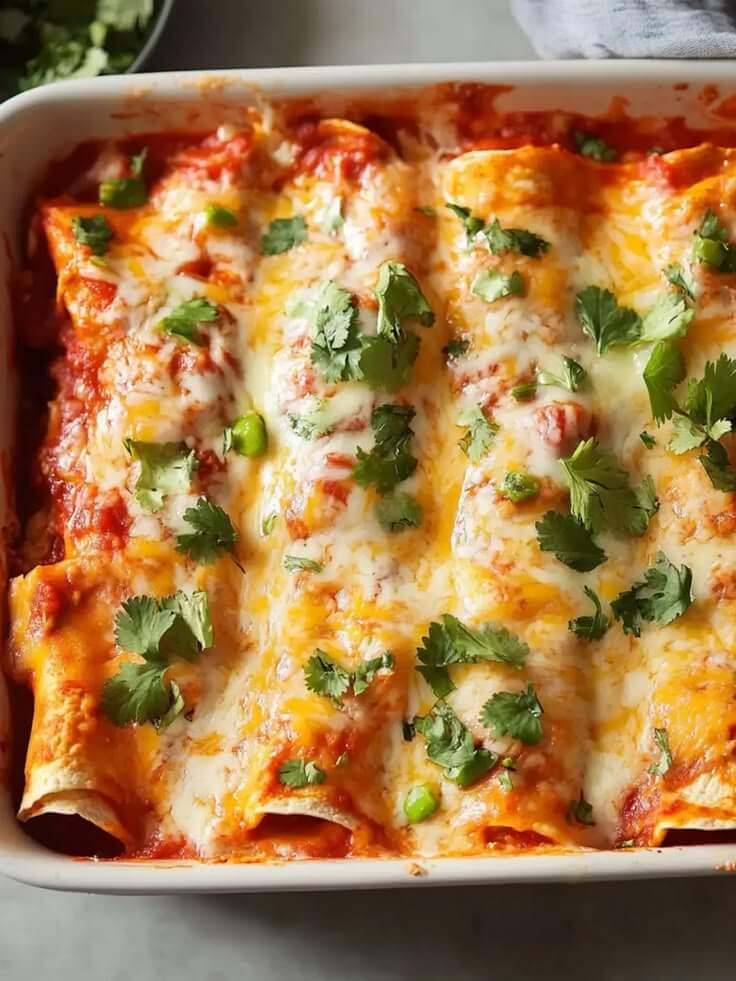 Easy-crockpot-chicken-enchilada-casserole-made-with-tender-shredded-chicken-rich-enchilada-sauce-soft-corn-tortillas-and-melted-cheese