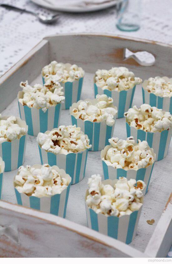 Popcorn-served-in-small-striped-party-boxes.