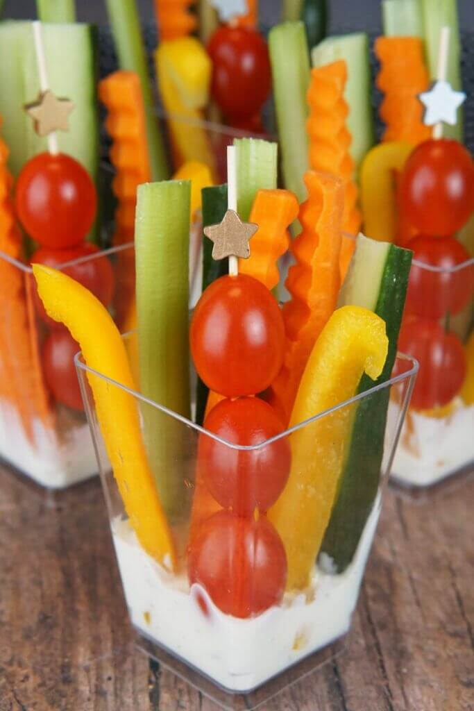 Fresh vegetable sticks with dip in cups-cucumber-bell-peppers-carrots-celery-and-cherry-baby-shower-food-ideas