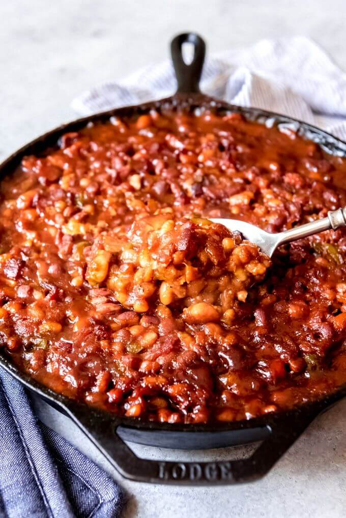 Baked-beans-in-a-rich-sauce-served-in-a-skillet-with-a-spoon
