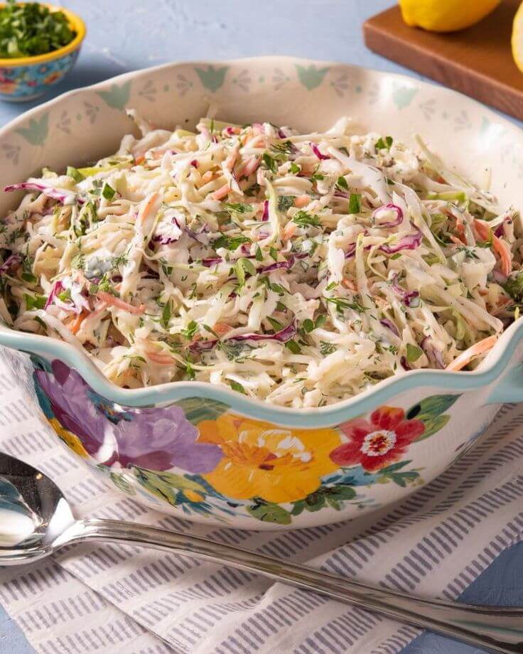 Creamy-coleslaw-with-shredded-cabbage-carrots-and-fresh-herbs-in-a-serving-bowl