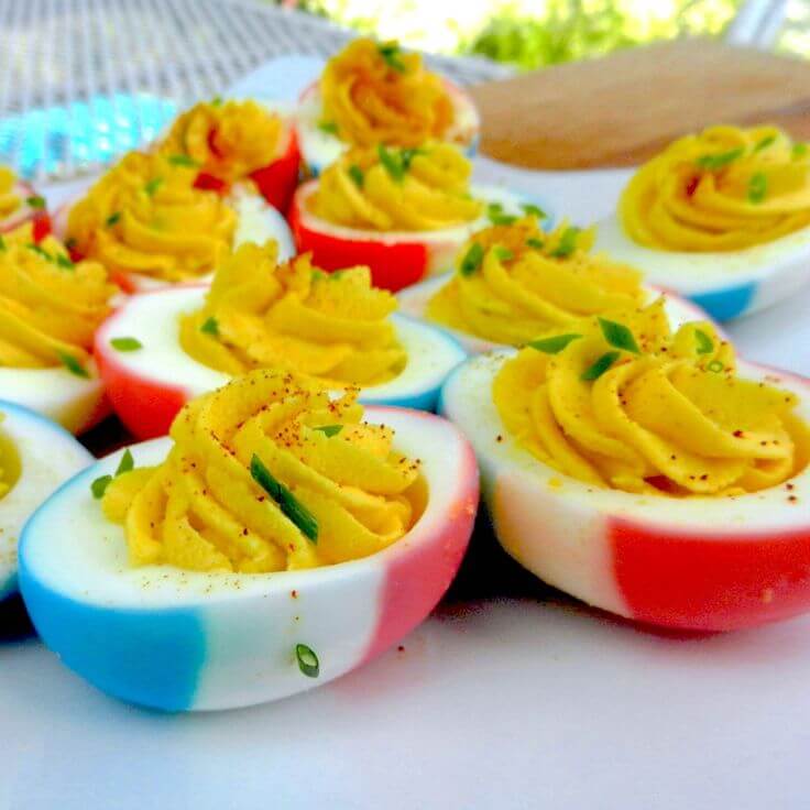 Colorful-deviled-eggs-with-paprika-and-creamy-filling-on-a-platter
